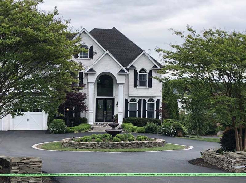 Simple white house with a newly resurfaced asphalt driveway in Frederick, MD